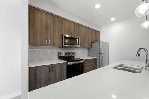 313-700 Shawnee Square Sw, Calgary, AB - Indoor Photo Showing Kitchen With Stainless Steel Kitchen With Double Sink