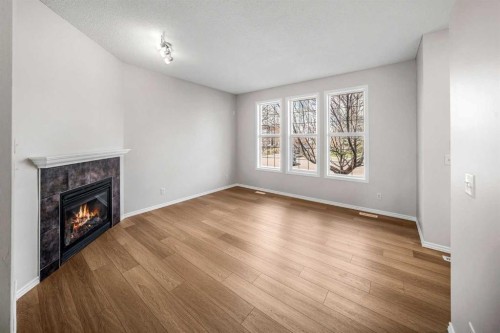 99 Covemeadow Close Ne, Calgary, AB - Indoor Photo Showing Living Room With Fireplace