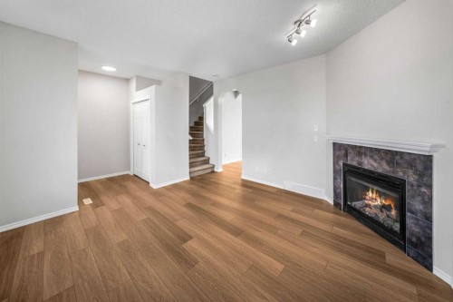 99 Covemeadow Close Ne, Calgary, AB - Indoor Photo Showing Other Room With Fireplace