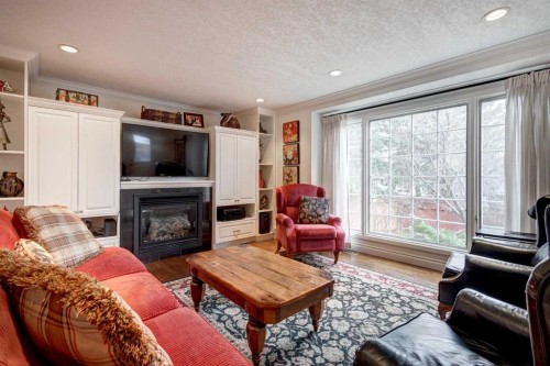 103 Pump Hill Place Sw, Calgary, AB - Indoor Photo Showing Living Room With Fireplace