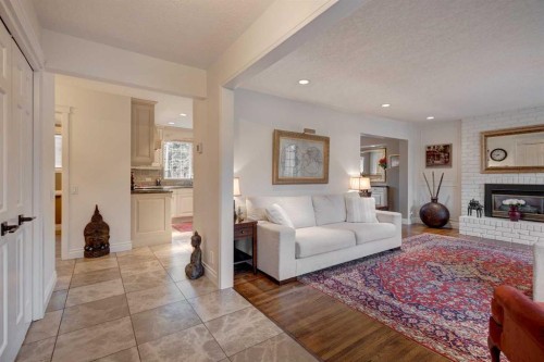 103 Pump Hill Place Sw, Calgary, AB - Indoor Photo Showing Living Room With Fireplace