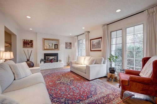 103 Pump Hill Place Sw, Calgary, AB - Indoor Photo Showing Living Room With Fireplace