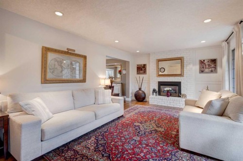 103 Pump Hill Place Sw, Calgary, AB - Indoor Photo Showing Living Room With Fireplace