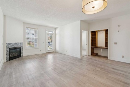 106-3650 Marda Link Sw, Calgary, AB - Indoor Photo Showing Living Room With Fireplace