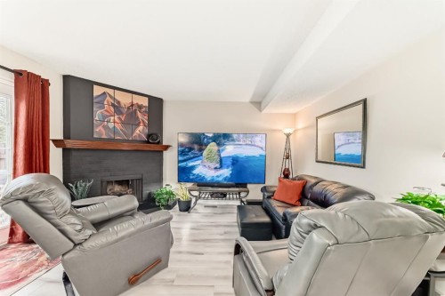 2-6503 Ranchview Drive Nw, Calgary, AB - Indoor Photo Showing Living Room With Fireplace