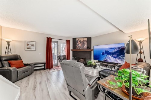 2-6503 Ranchview Drive Nw, Calgary, AB - Indoor Photo Showing Living Room With Fireplace