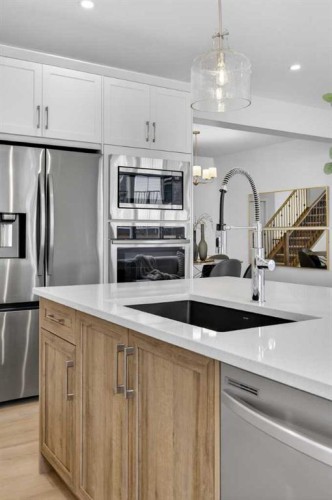 67 Versant Way Sw, Calgary, AB - Indoor Photo Showing Kitchen With Stainless Steel Kitchen With Double Sink With Upgraded Kitchen
