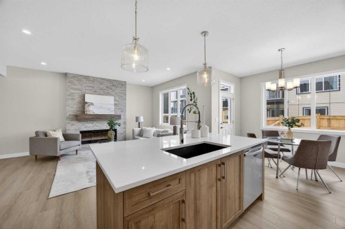 67 Versant Way Sw, Calgary, AB - Indoor Photo Showing Kitchen With Fireplace