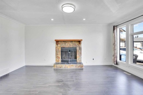 26 Falmead Bay Ne, Calgary, AB - Indoor Photo Showing Living Room With Fireplace