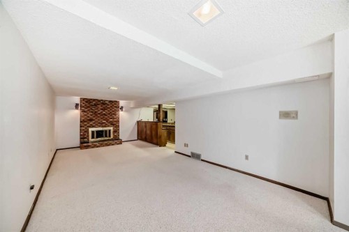 183 Dalcastle Way Nw, Calgary, AB - Indoor With Fireplace