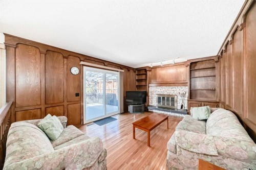 183 Dalcastle Way Nw, Calgary, AB - Indoor Photo Showing Living Room With Fireplace