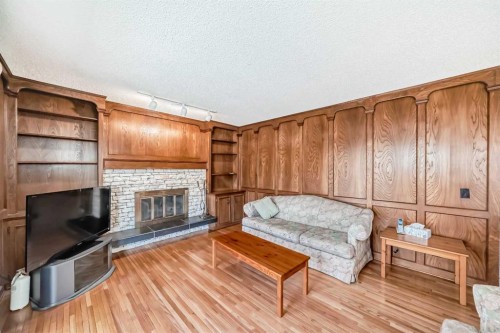 183 Dalcastle Way Nw, Calgary, AB - Indoor Photo Showing Living Room With Fireplace