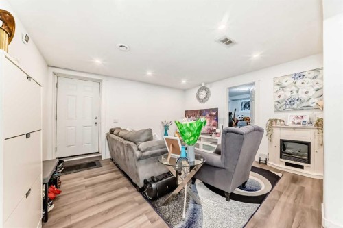 244 Coverdale Court Ne, Calgary, AB - Indoor Photo Showing Living Room With Fireplace