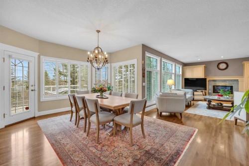 216 Evergreen Heath Sw, Calgary, AB - Indoor Photo Showing Dining Room With Fireplace
