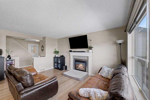 260 Covebrook Place Ne, Calgary, AB - Indoor Photo Showing Living Room With Fireplace
