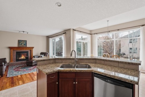 430 Discovery Ridge Boulevard Sw, Calgary, AB - Indoor Photo Showing Kitchen With Fireplace With Double Sink