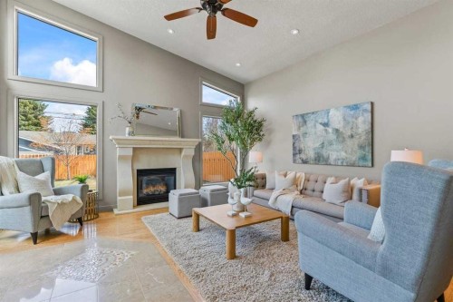36 Lake Twintree Place Se, Calgary, AB - Indoor Photo Showing Living Room With Fireplace