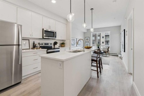 201-655 Shawnee Square Sw, Calgary, AB - Indoor Photo Showing Kitchen With Stainless Steel Kitchen With Double Sink With Upgraded Kitchen