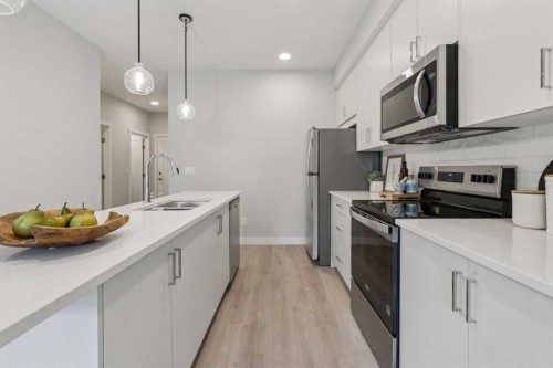 201-655 Shawnee Square Sw, Calgary, AB - Indoor Photo Showing Kitchen With Double Sink With Upgraded Kitchen