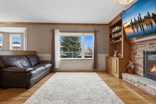 729 Woodbriar Place Sw, Calgary, AB - Indoor Photo Showing Living Room With Fireplace