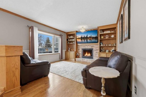 729 Woodbriar Place Sw, Calgary, AB - Indoor Photo Showing Living Room With Fireplace