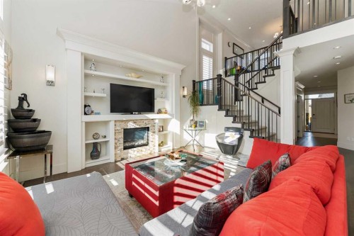 129 Kinniburgh Gardens, Chestermere, AB - Indoor Photo Showing Living Room With Fireplace