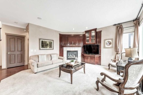 40 Cougar Ridge Heights Sw, Calgary, AB - Indoor Photo Showing Living Room With Fireplace