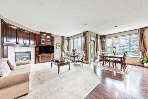 40 Cougar Ridge Heights Sw, Calgary, AB - Indoor Photo Showing Living Room With Fireplace