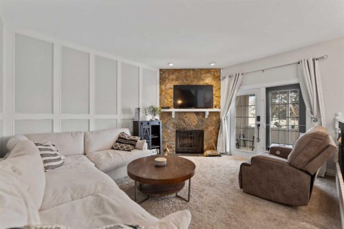 436 Ranchridge Bay Nw, Calgary, AB - Indoor Photo Showing Living Room With Fireplace