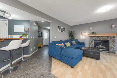 56 Evansbrooke Landing, Calgary, AB - Indoor Photo Showing Living Room With Fireplace