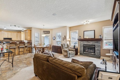 937 Cimarron Park Close, Okotoks, AB - Indoor Photo Showing Living Room With Fireplace