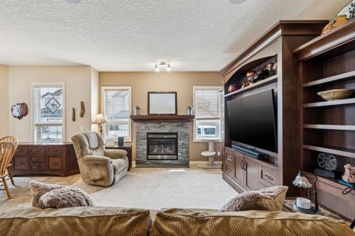 937 Cimarron Park Close, Okotoks, AB - Indoor Photo Showing Living Room With Fireplace