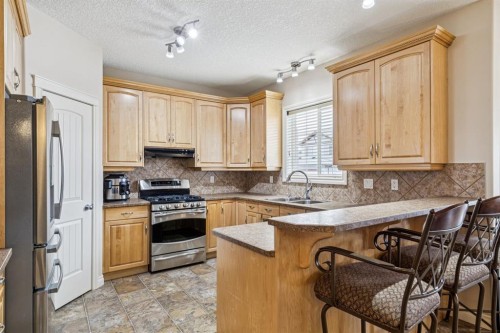 937 Cimarron Park Close, Okotoks, AB - Indoor Photo Showing Kitchen With Double Sink