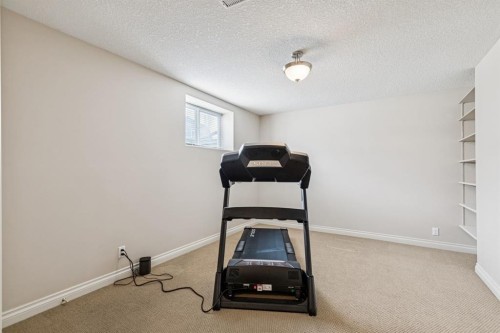 937 Cimarron Park Close, Okotoks, AB - Indoor Photo Showing Gym Room