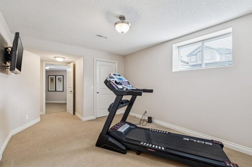 937 Cimarron Park Close, Okotoks, AB - Indoor Photo Showing Gym Room