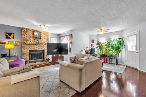 53 Shawfield Road Sw, Calgary, AB - Indoor Photo Showing Living Room With Fireplace