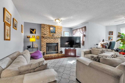 53 Shawfield Road Sw, Calgary, AB - Indoor Photo Showing Living Room With Fireplace