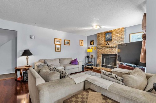 53 Shawfield Road Sw, Calgary, AB - Indoor Photo Showing Living Room With Fireplace