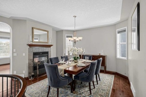 70 Panatella Circle Nw, Calgary, AB - Indoor Photo Showing Dining Room With Fireplace