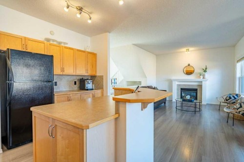 322 Rockyspring Circle Nw, Calgary, AB - Indoor Photo Showing Kitchen With Fireplace
