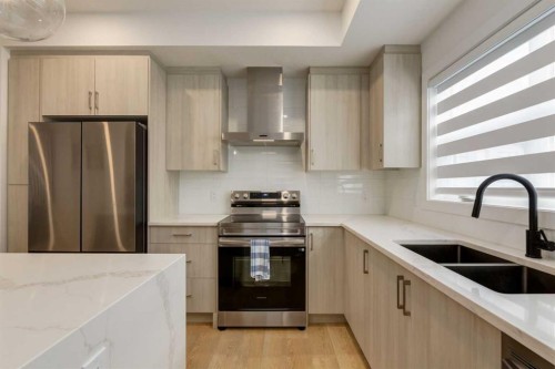 94-903 Mahogany Boulevard Se, Calgary, AB - Indoor Photo Showing Kitchen With Stainless Steel Kitchen With Double Sink