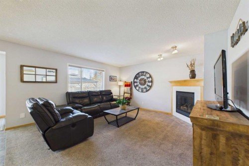 190 Brightonstone Bay Se, Calgary, AB - Indoor Photo Showing Living Room With Fireplace