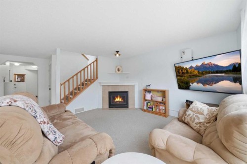 62 New Brighton Circle Se, Calgary, AB - Indoor Photo Showing Living Room With Fireplace