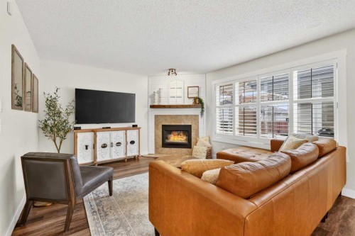 60 Inverness Drive Se, Calgary, AB - Indoor Photo Showing Living Room With Fireplace