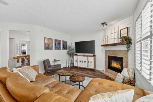60 Inverness Drive Se, Calgary, AB - Indoor Photo Showing Living Room With Fireplace