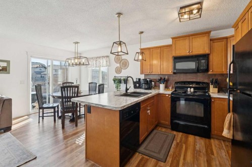 144 Canals Circle Sw, Airdrie, AB - Indoor Photo Showing Kitchen With Double Sink