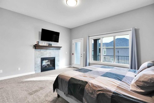 3 Muirfield Close, Lyalta, AB - Indoor Photo Showing Bedroom With Fireplace