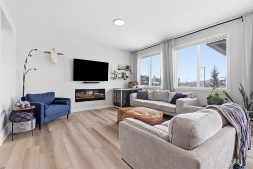 3 Sundown Crescent, Cochrane, AB - Indoor Photo Showing Living Room With Fireplace
