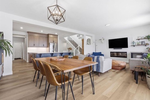 3 Sundown Crescent, Cochrane, AB - Indoor Photo Showing Dining Room With Fireplace