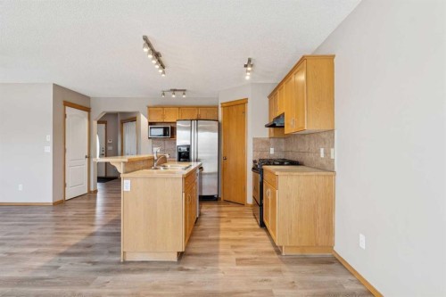 111 Luxstone Crescent Sw, Airdrie, AB - Indoor Photo Showing Kitchen With Double Sink